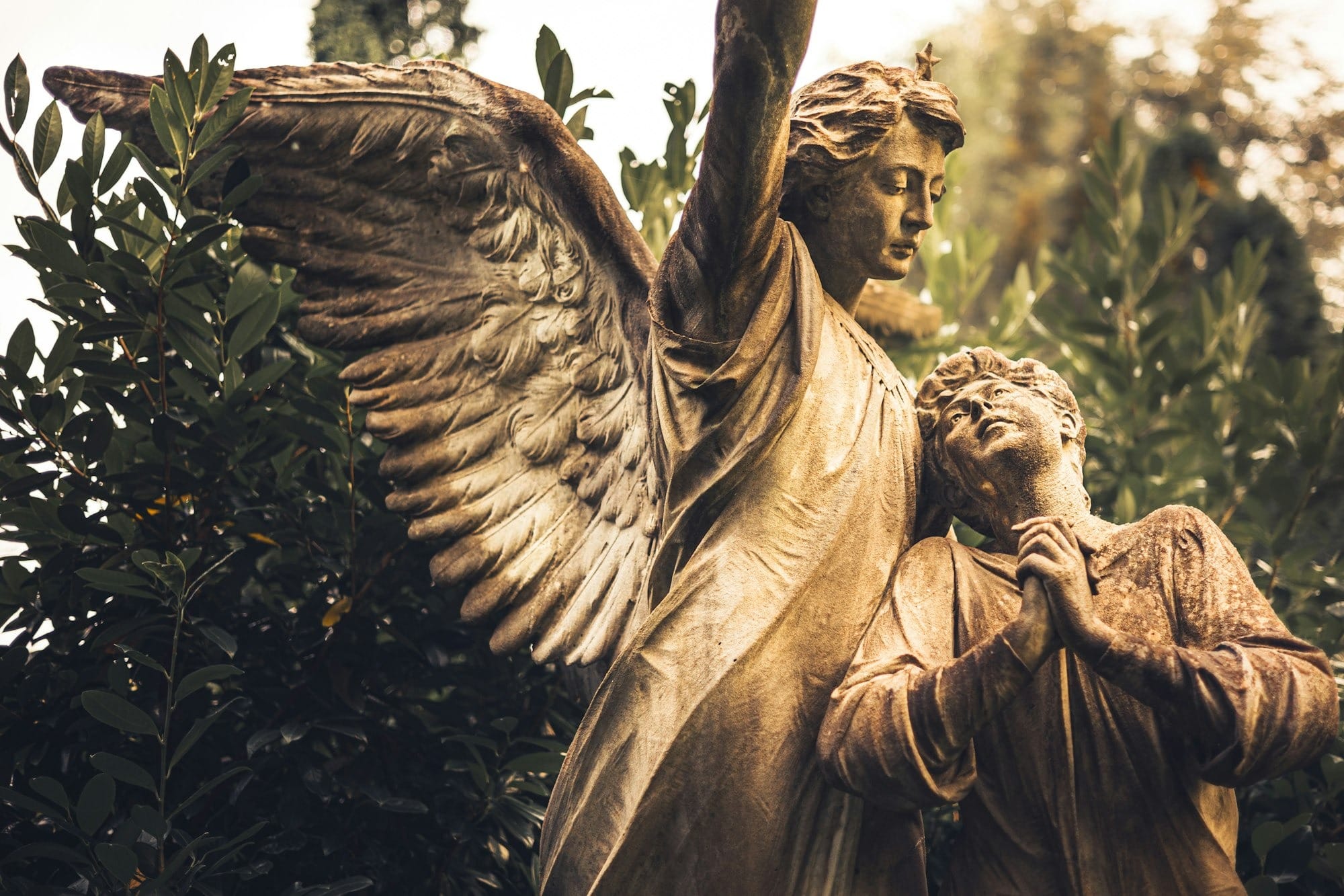 a statue of an angel holding a child